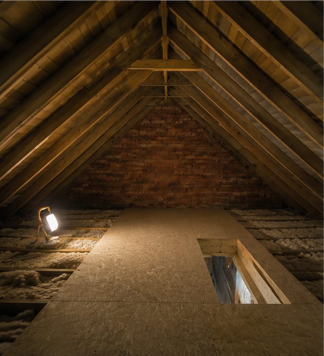 Before: the roof slope of a part-converted chalet bungalow loft, with thin foil-backed board between the rafters